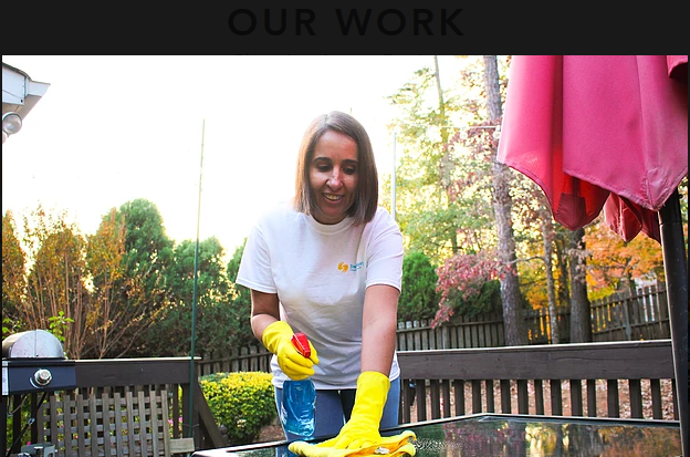 A girl wearing yellow gloves cleaning a table
